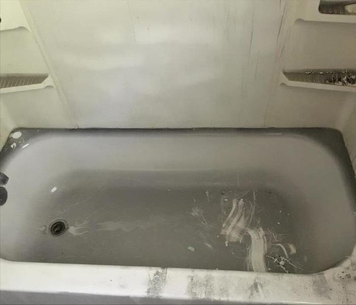 Soot covered bath tub after grease fire in home