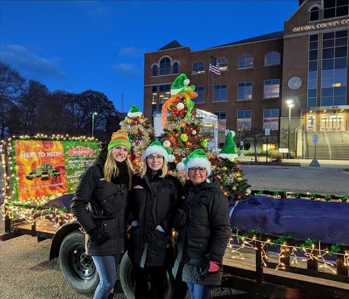Marketing Girls standing in front of decorated trailer