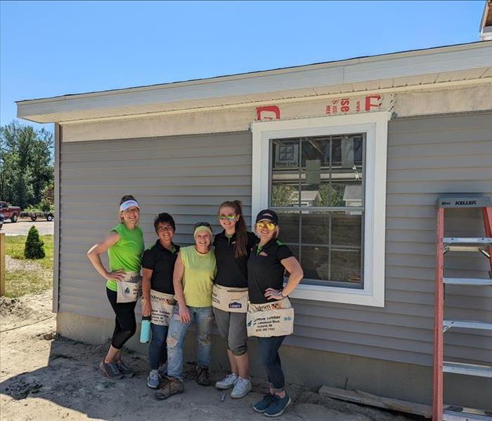 Ladies standing in front of Habitat for Humanity home