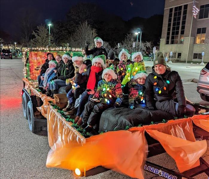 SERVPRO employees and family riding in parade float