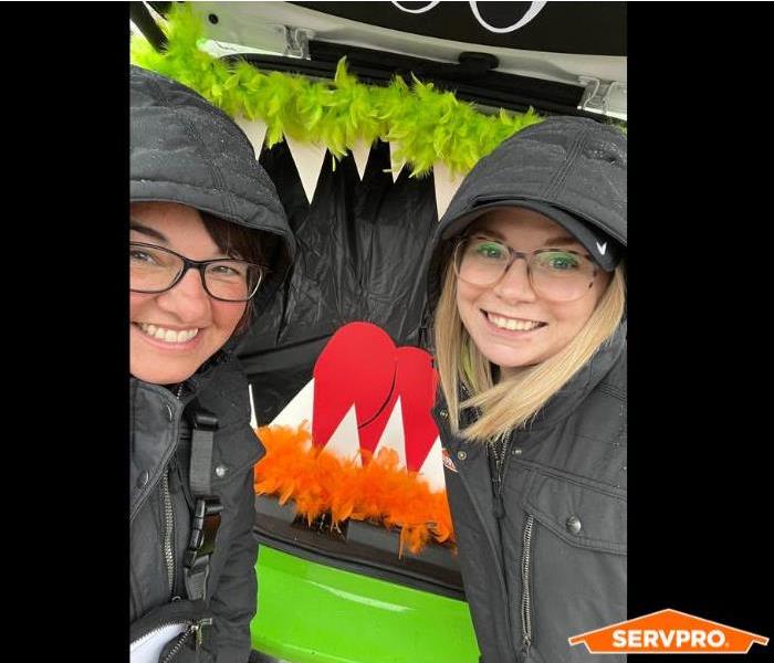 Marketing Girls standing in front of SERVPRO 