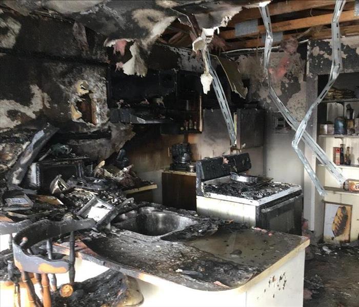 A room severely damaged after an apartment fire.