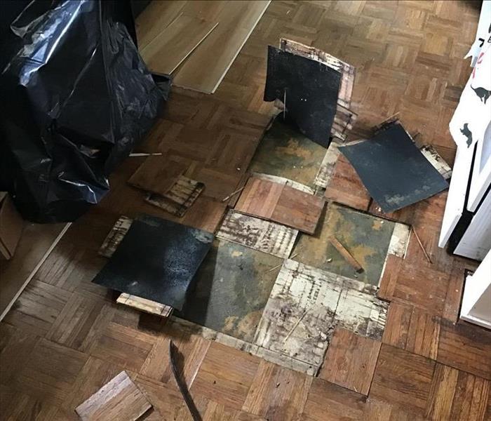Five layers of flooring affected by water damage