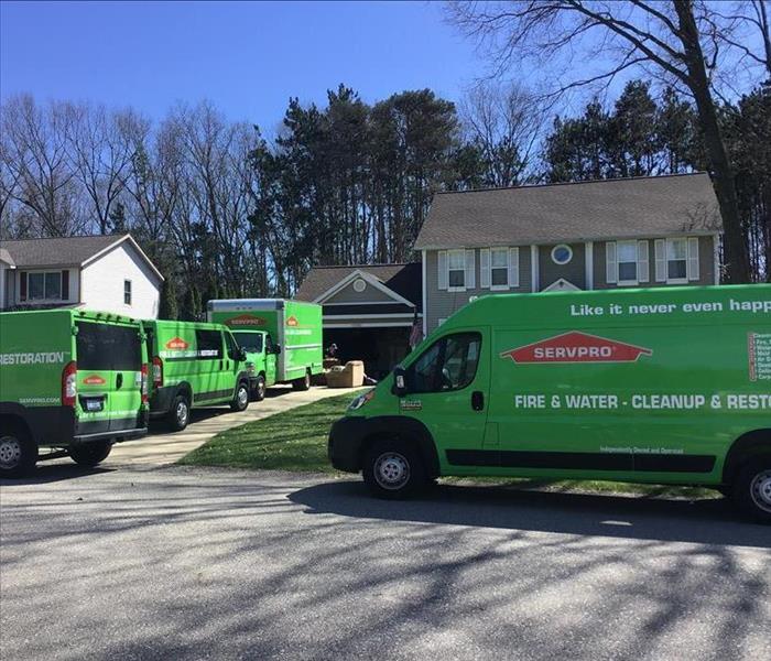 Multiple SERVPRO vehicles parked at customers home