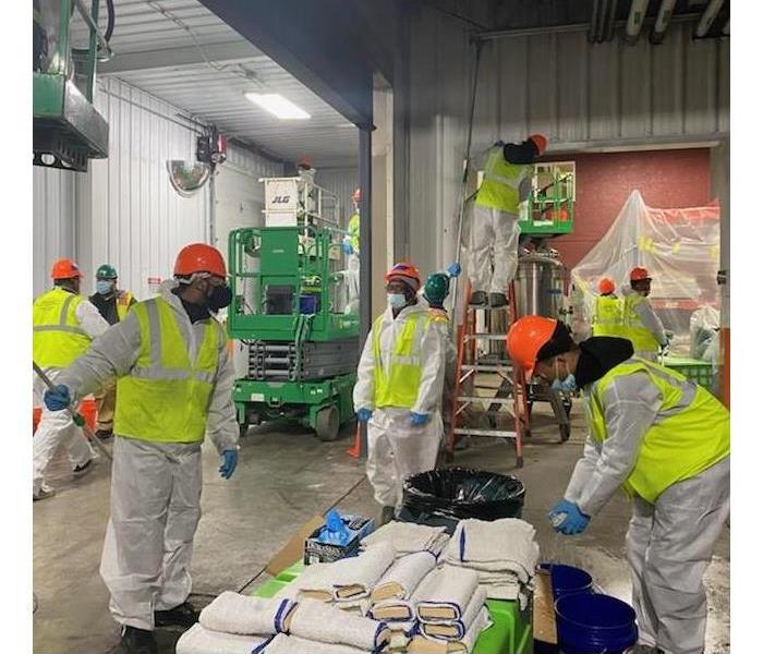 SERVPRO technicians cleaning up fire damage in a production facility
